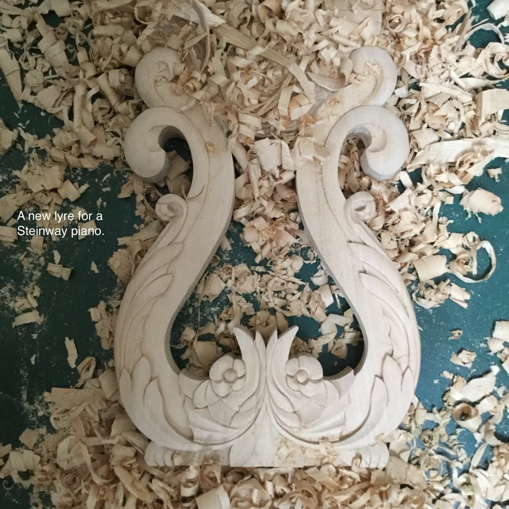 A newly carved lyre for a Steinway Piano