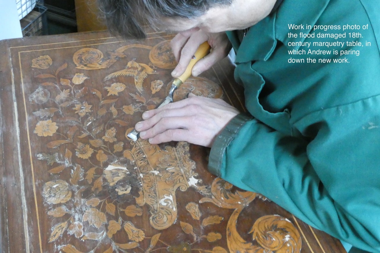 Work in progress photo of the flood damaged 18th century marquetry table, in which Andrew is paring down the new work.